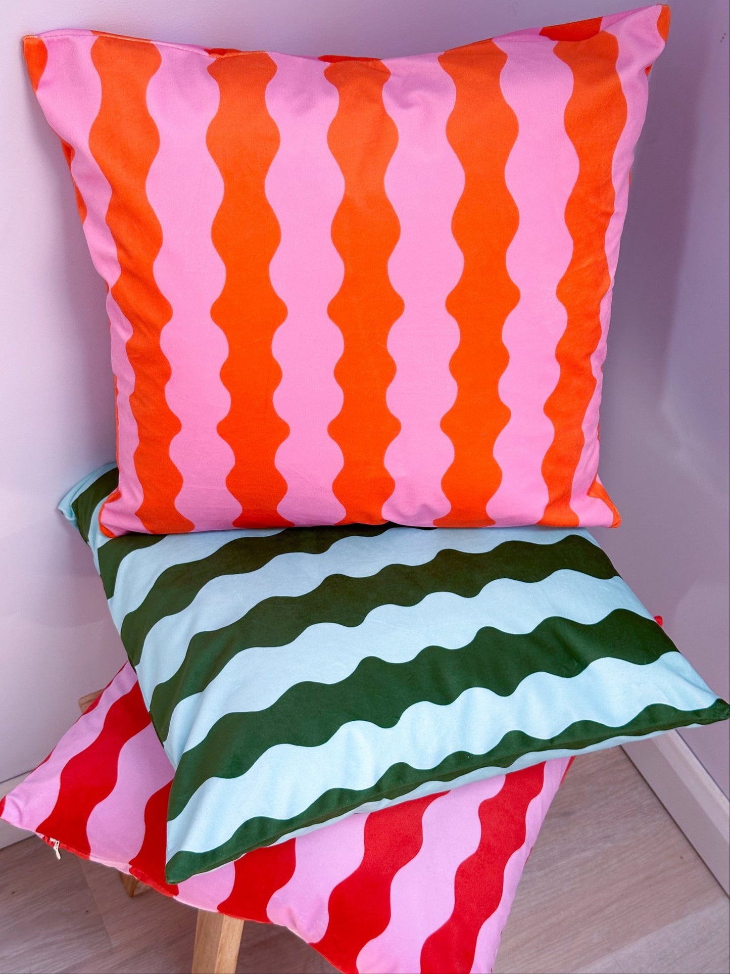 68de2f7800ddcb1087155c2d_orange-and-pink-wavy-cushion_1760526131174.jpg