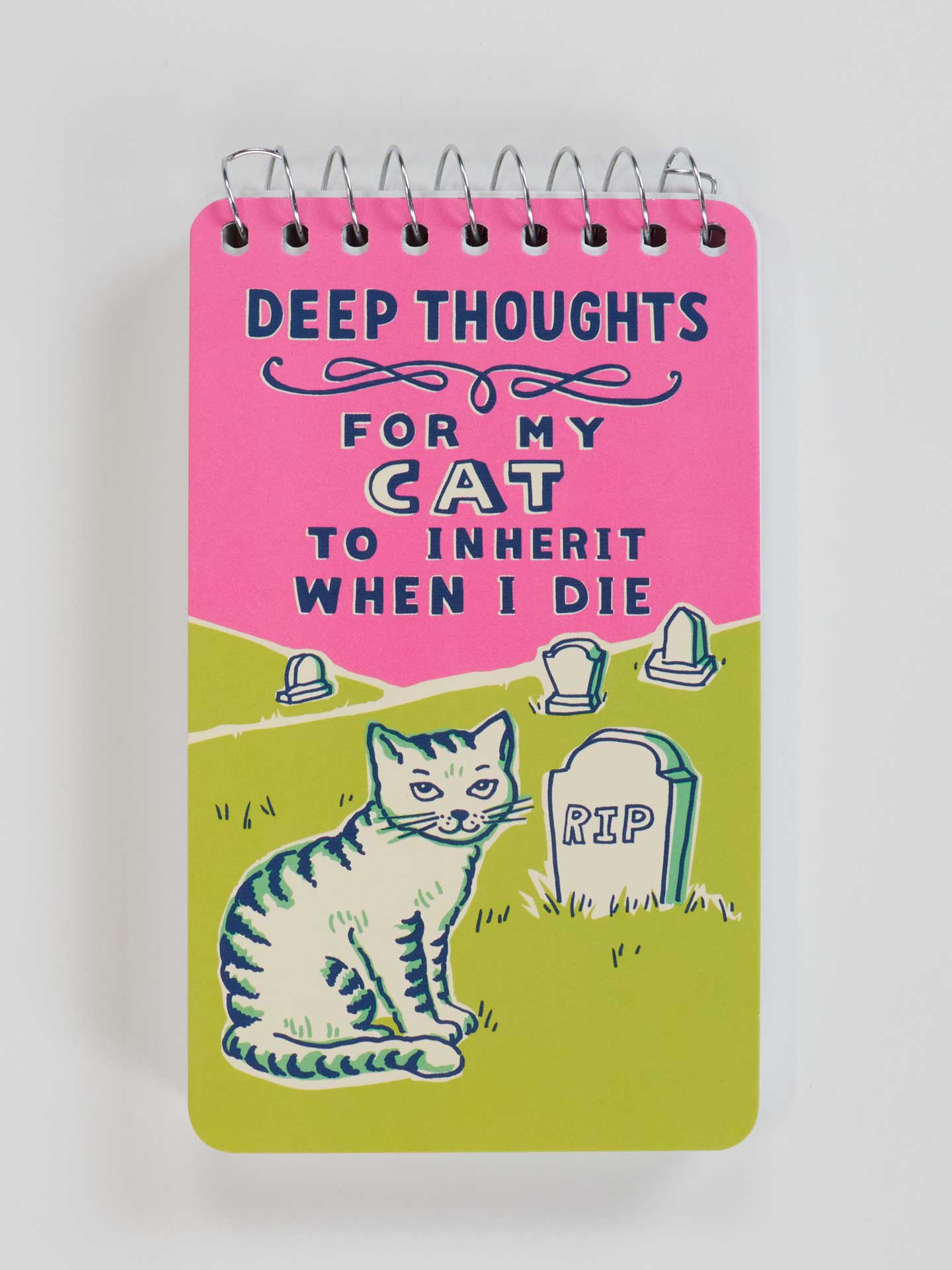 Notebook with a pink and green cover featuring text and a cat illustration on a white background