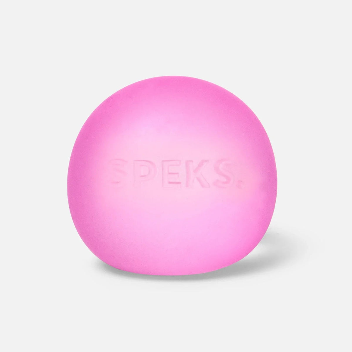 A bright pink oval silicone product with the brand name 'SPEKS.' embossed on the front, set against a clean, light gray background.