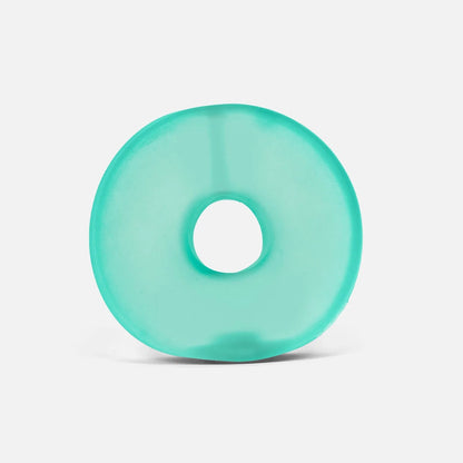 A translucent aqua green donut-shaped ring, likely a silicone bath mat or pool float, centered on a clean white background.