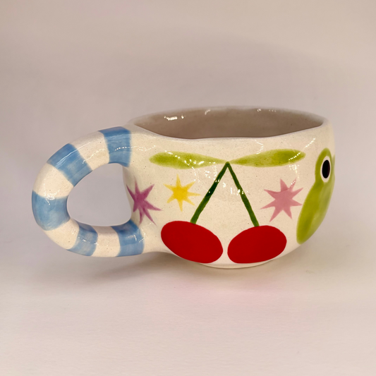 Ceramic mug with colorful design on a plain background