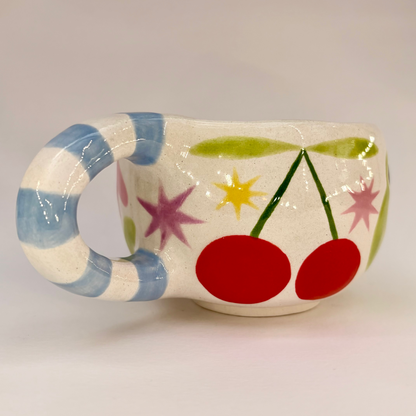 Ceramic cup with colorful design on a plain background