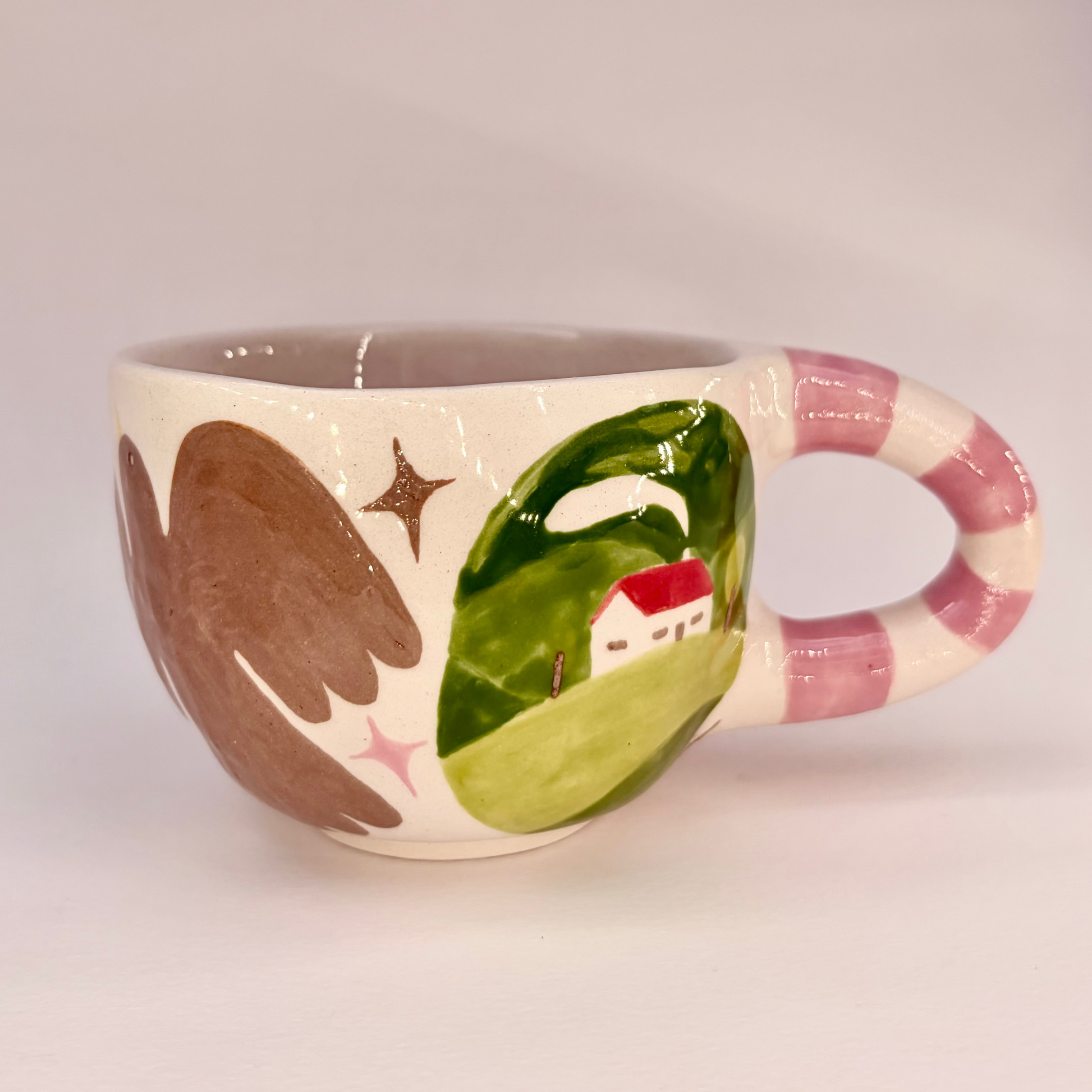 Ceramic mug with artistic design on a plain background