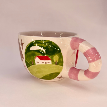 Ceramic mug with a scenic design on a plain background
