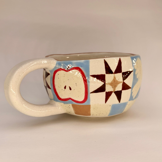 Ceramic mug with colorful geometric patterns on a beige background