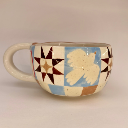 Ceramic mug with geometric pattern and bird illustration on a beige background