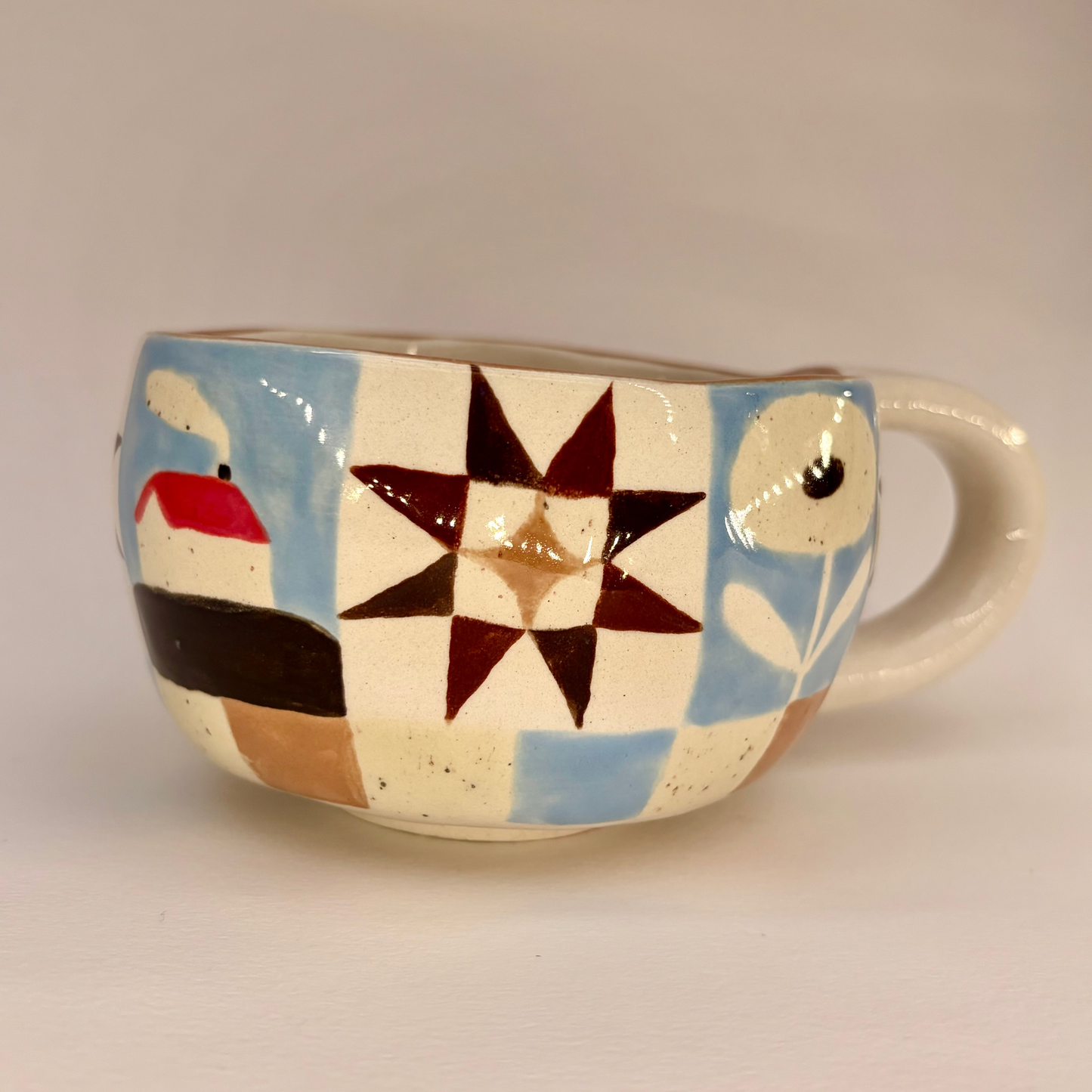 Ceramic mug with geometric pattern on a plain background