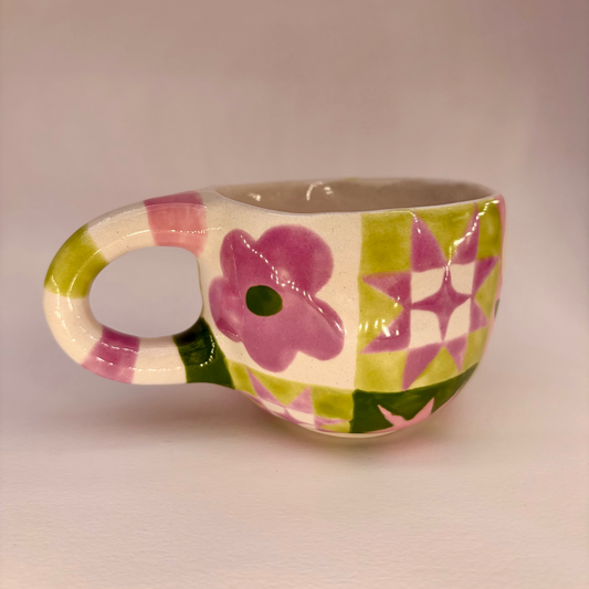 Ceramic mug with floral design on a plain background