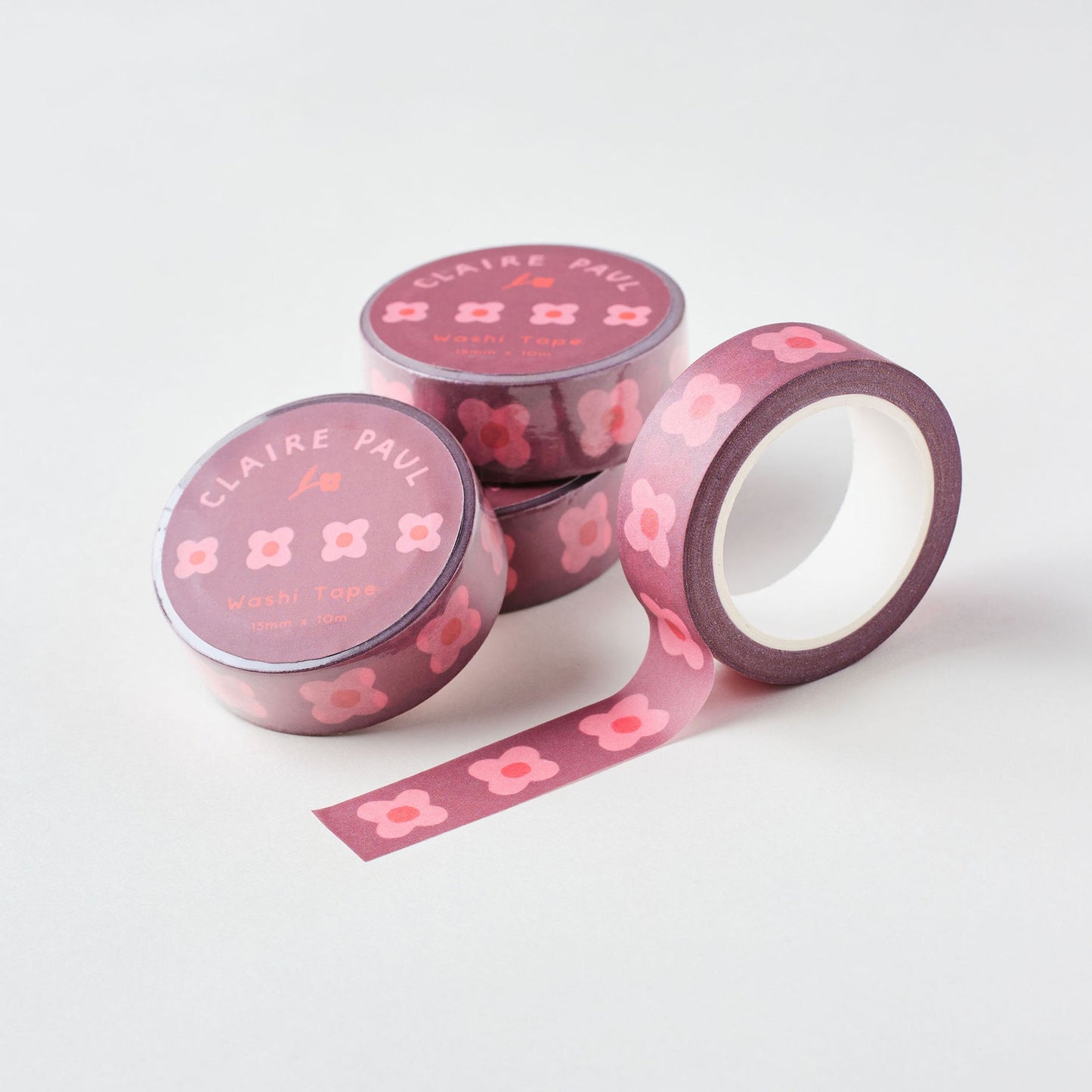 Rolls of tape with pink block flower print stacked against each other