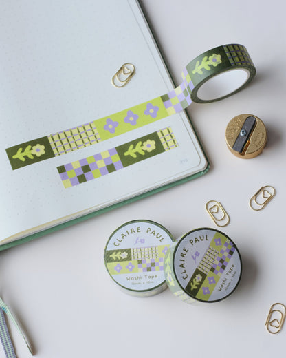 Washi tape with floral patterns, on a white surface featuring a sharpener and paperclips