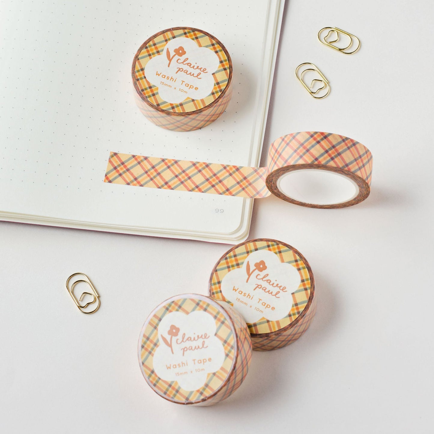 Yellow check patterned washi tape rolls against a white background